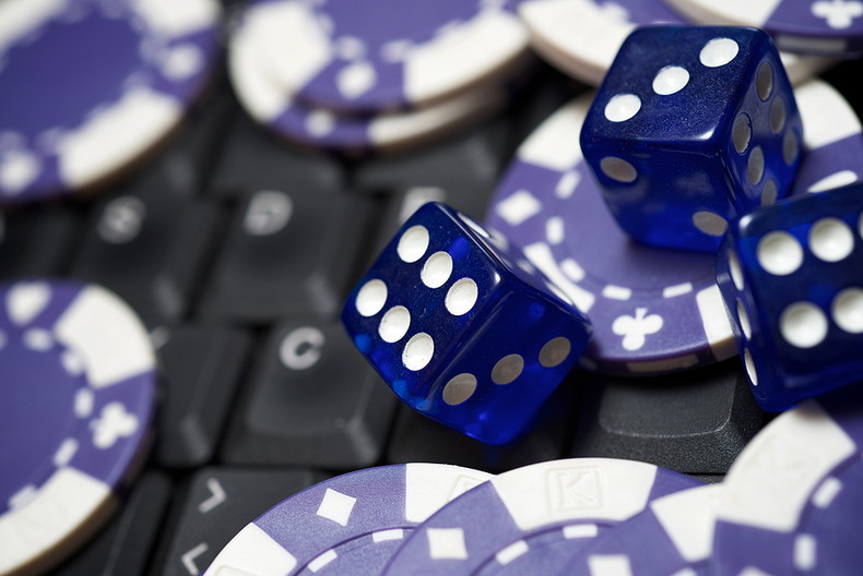 Blue Casino Chips and Dice on Keyboard