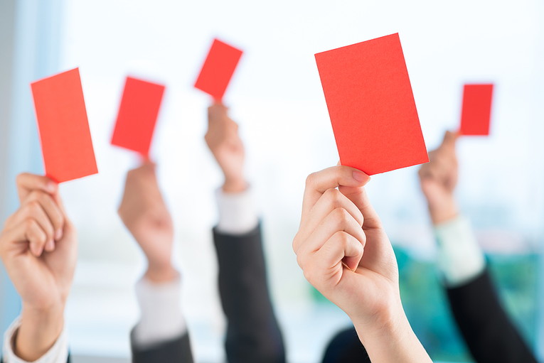 Business People Holding Up Red Cards