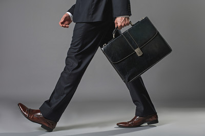 Businessman Walking Holding Briefcase