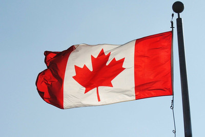 Canadian Flag Against Blue Sky