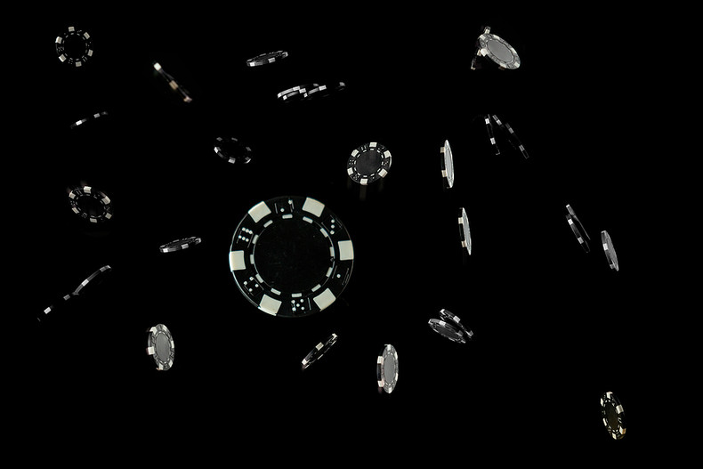Casino Chips Falling Against a Black Background