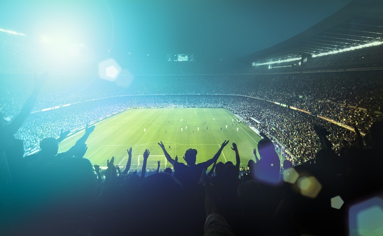 Football Fans in Stadium During Night Match