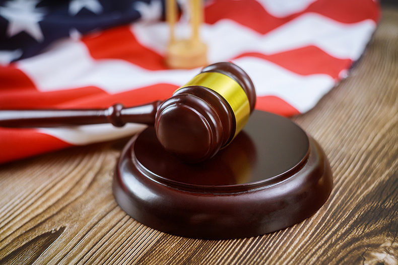 Gavel on Wooden Desk with USA Flag