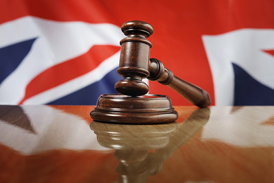 Gavel on Wooden Table Against Union Jack