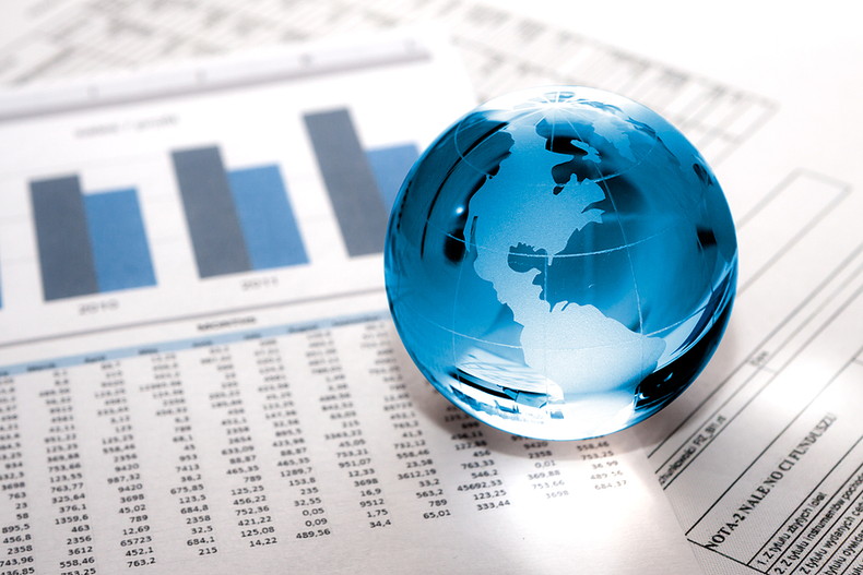 Globe Paperweight on Financial Figures