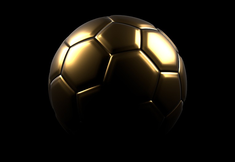 Golden Football Against Dark Background