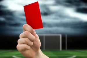 Red Card Held Against Stormy Sky