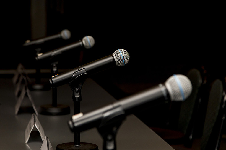 Row of Microphones in Conference Room