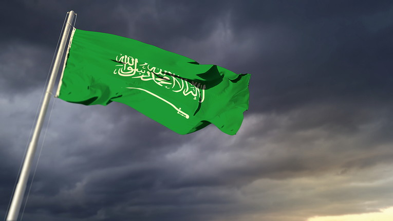 Saudi Flag Against Dark Clouds
