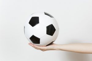Woman Holding Out a Football
